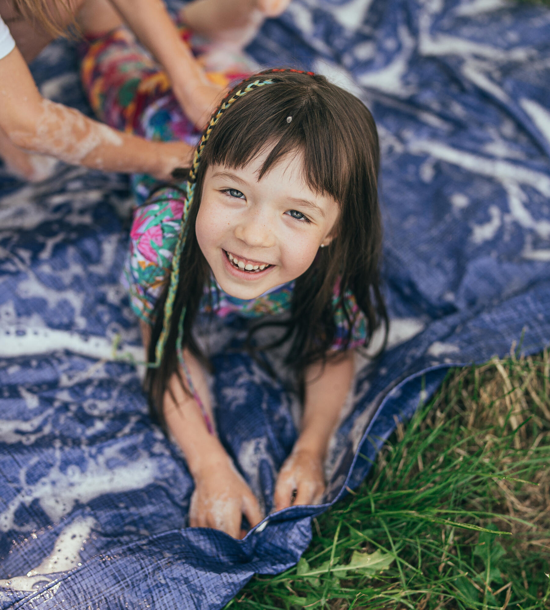 playmaker having fund during a get messy class on the bubbly slip and slide